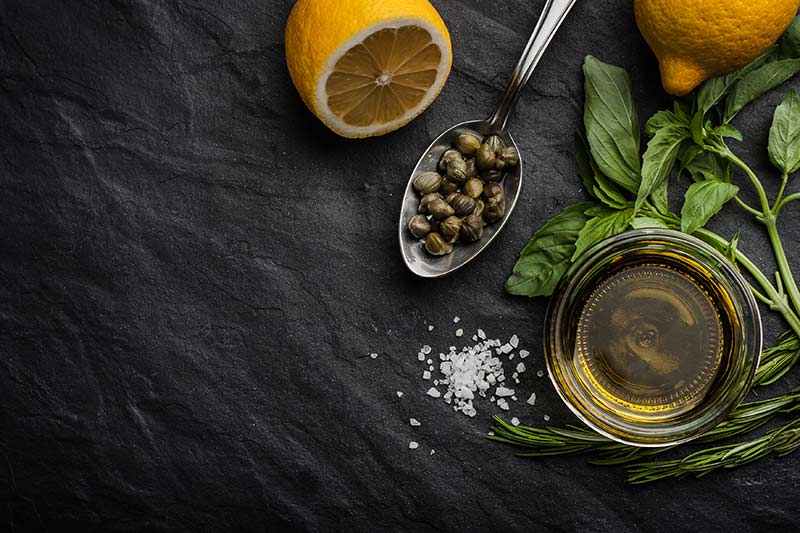 Green capers on a spoon