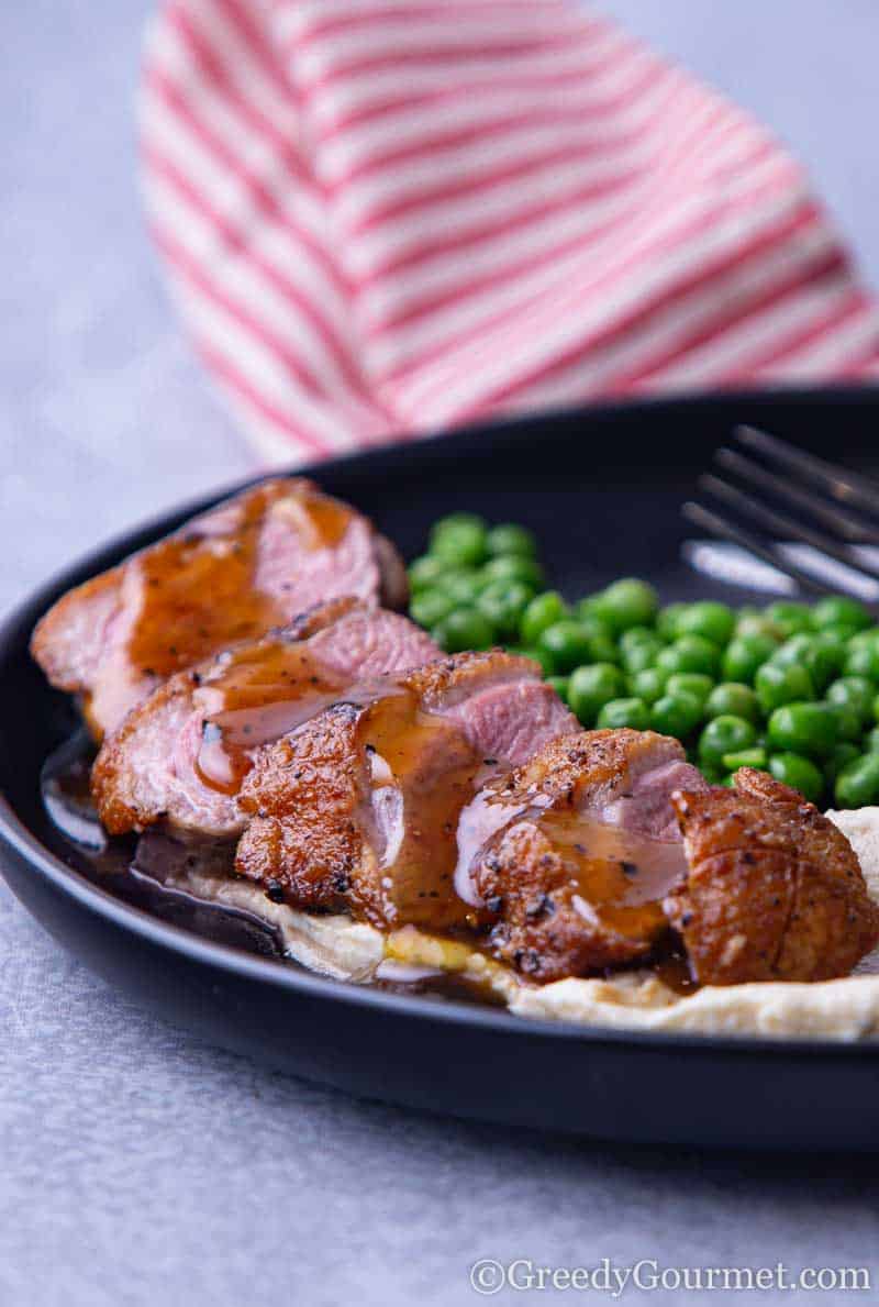 Full plate of a duck breast dish