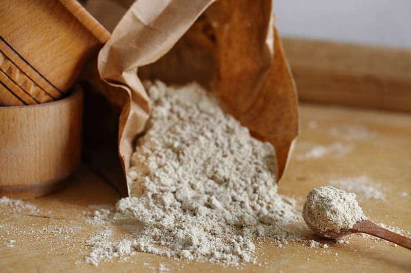 Hazelnut flour and a wooden spoon