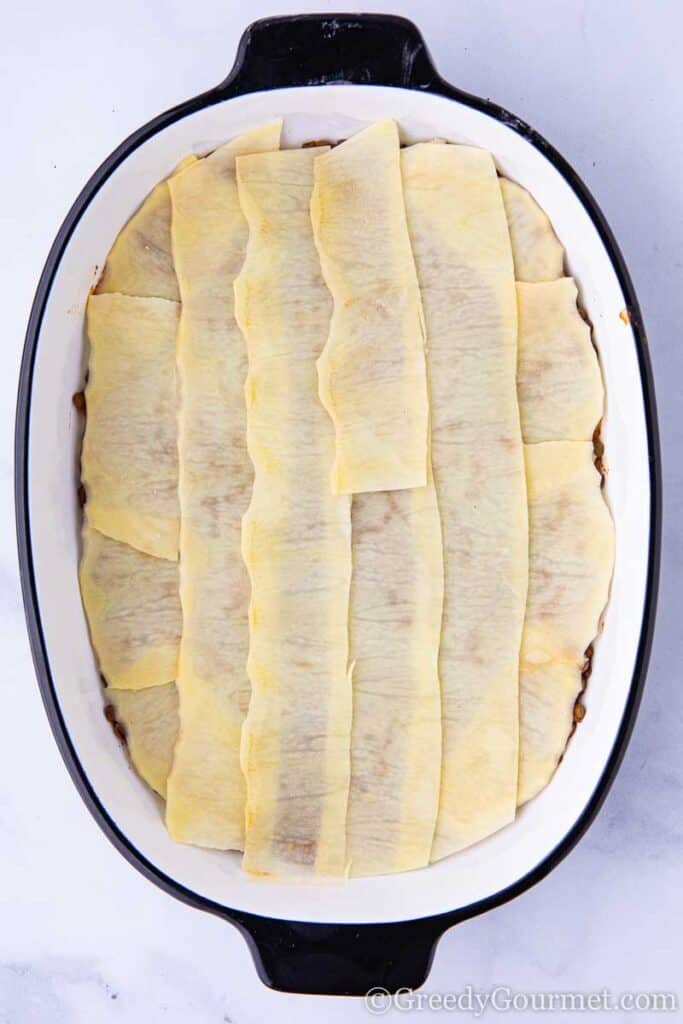 Layers of potato to make a vegan moussaka