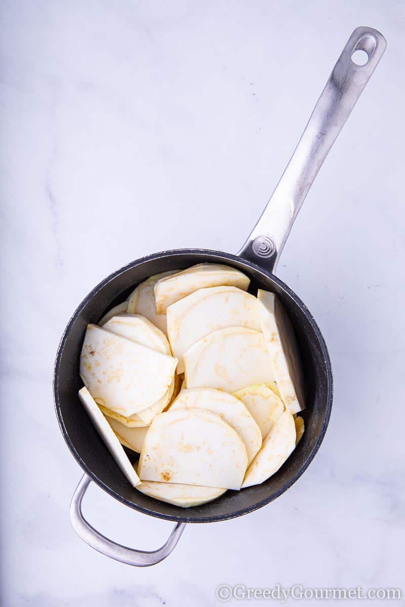 Raw slices of celery root to make a celery root puree