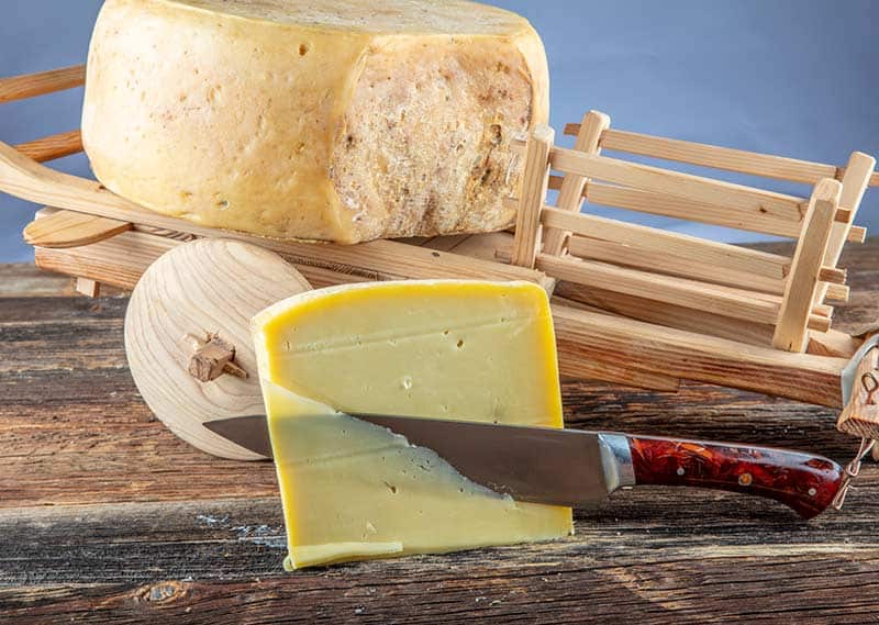 Slice of gruyere being removed
