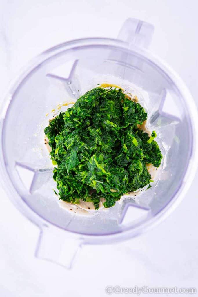 Thawed spinach in a blender