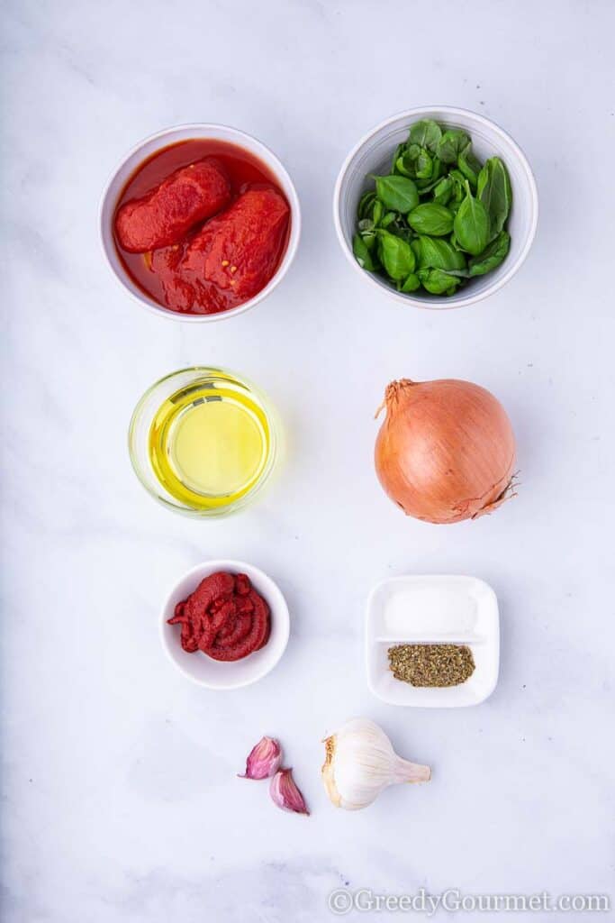 Tomato, basil, onion & garlic in bowls