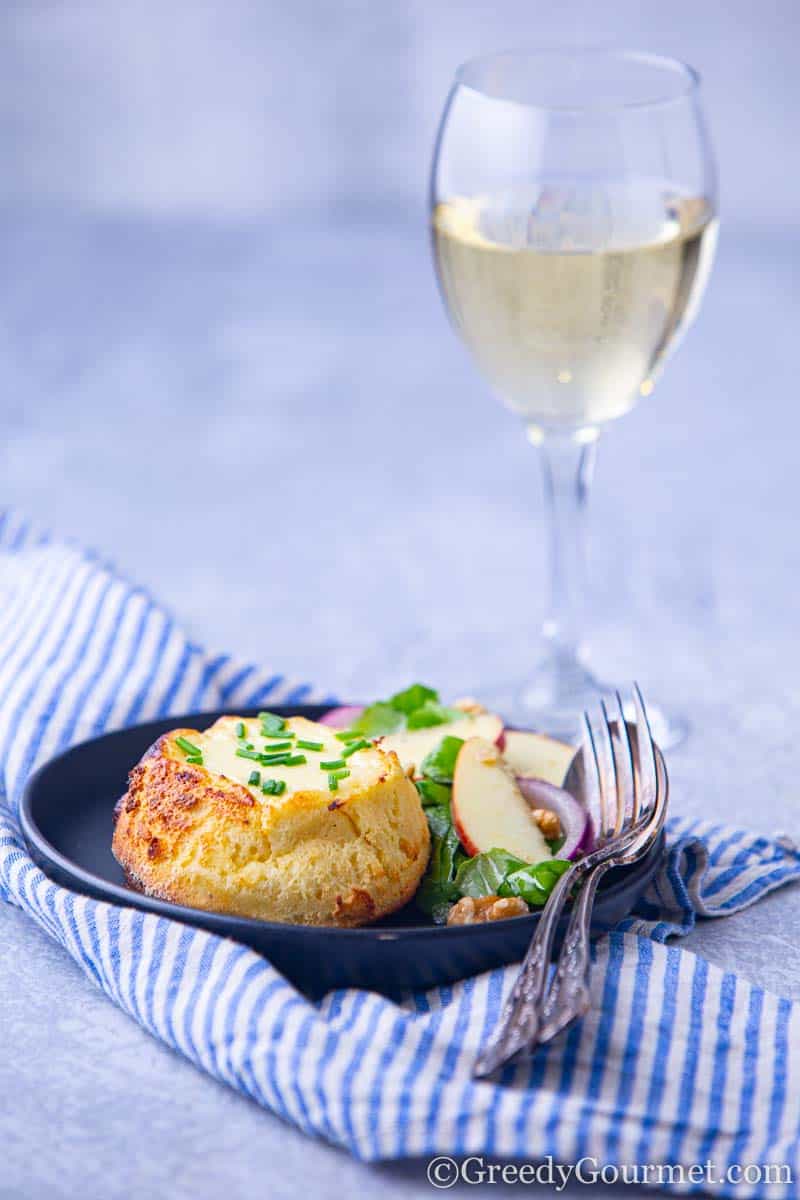 A plate of souffle recipe and a glass of white wine