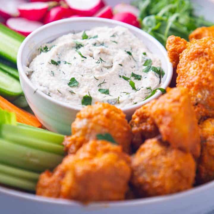 Bowl of cashew ranch recipe and hot wings