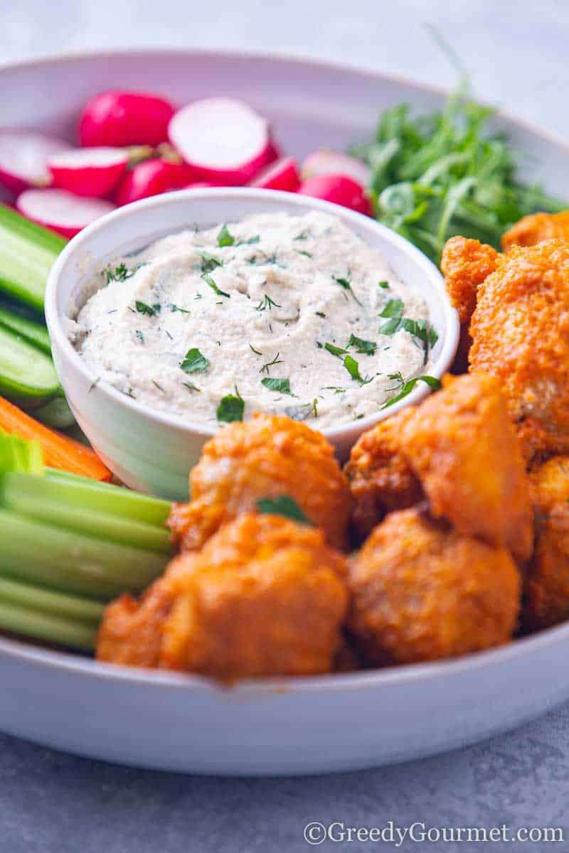 Bowl of cashew ranch recipe and hot wings