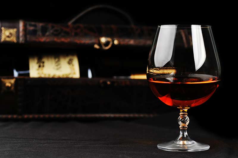 Half pour of cognac in a clear glass