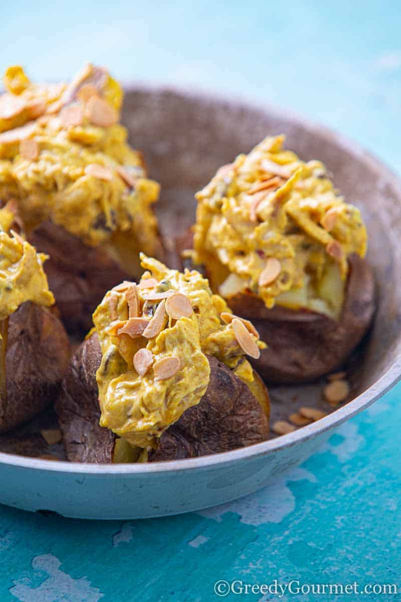 Plate full of three baked potatoes