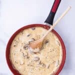 Mushrooms and sauce being sauteed in a pan to make a mushroom sauce recipe