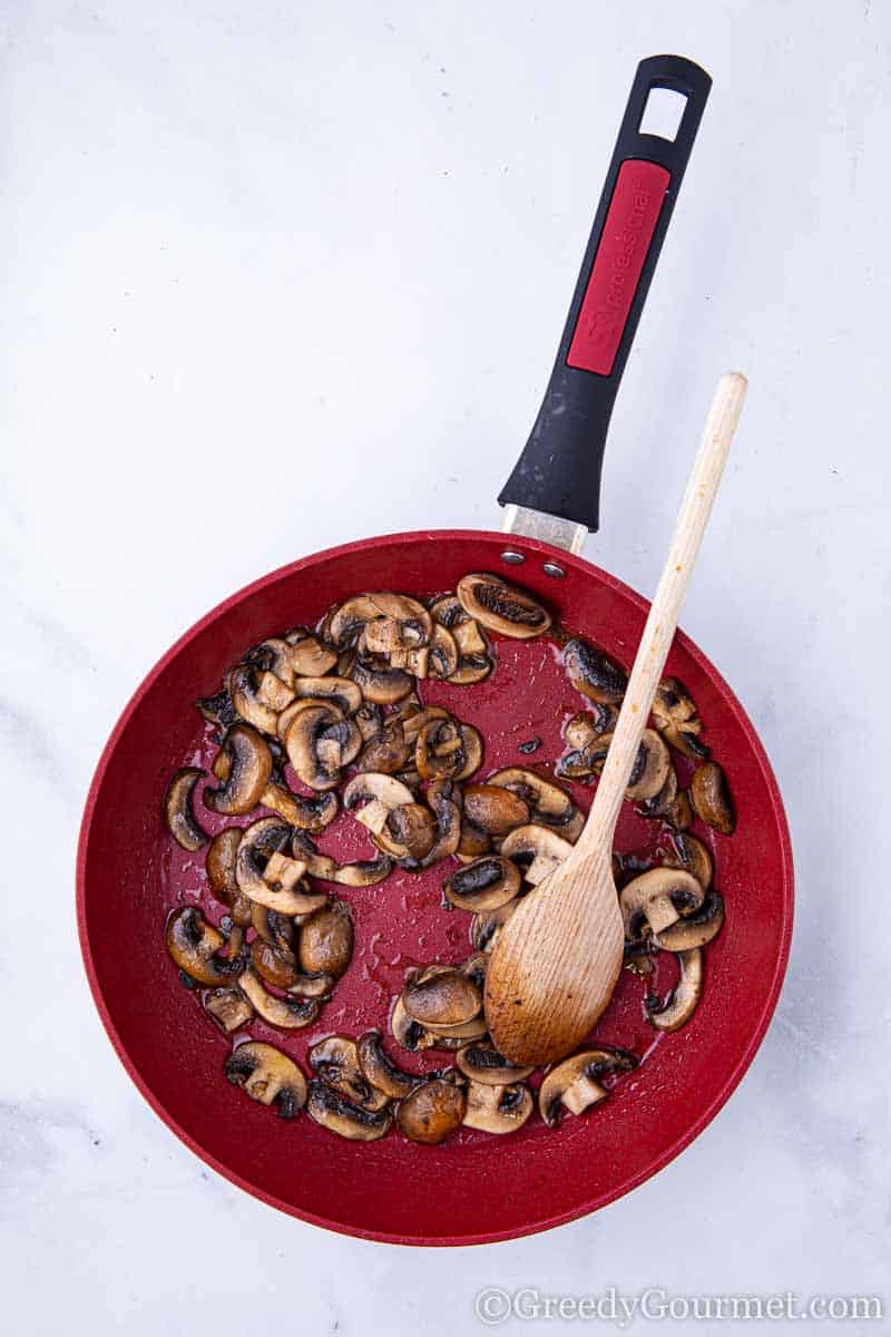 Mushrooms frying in a pan