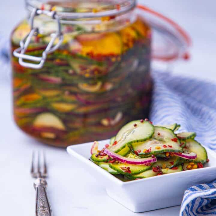 Pickled cucumbers in a plate with spices