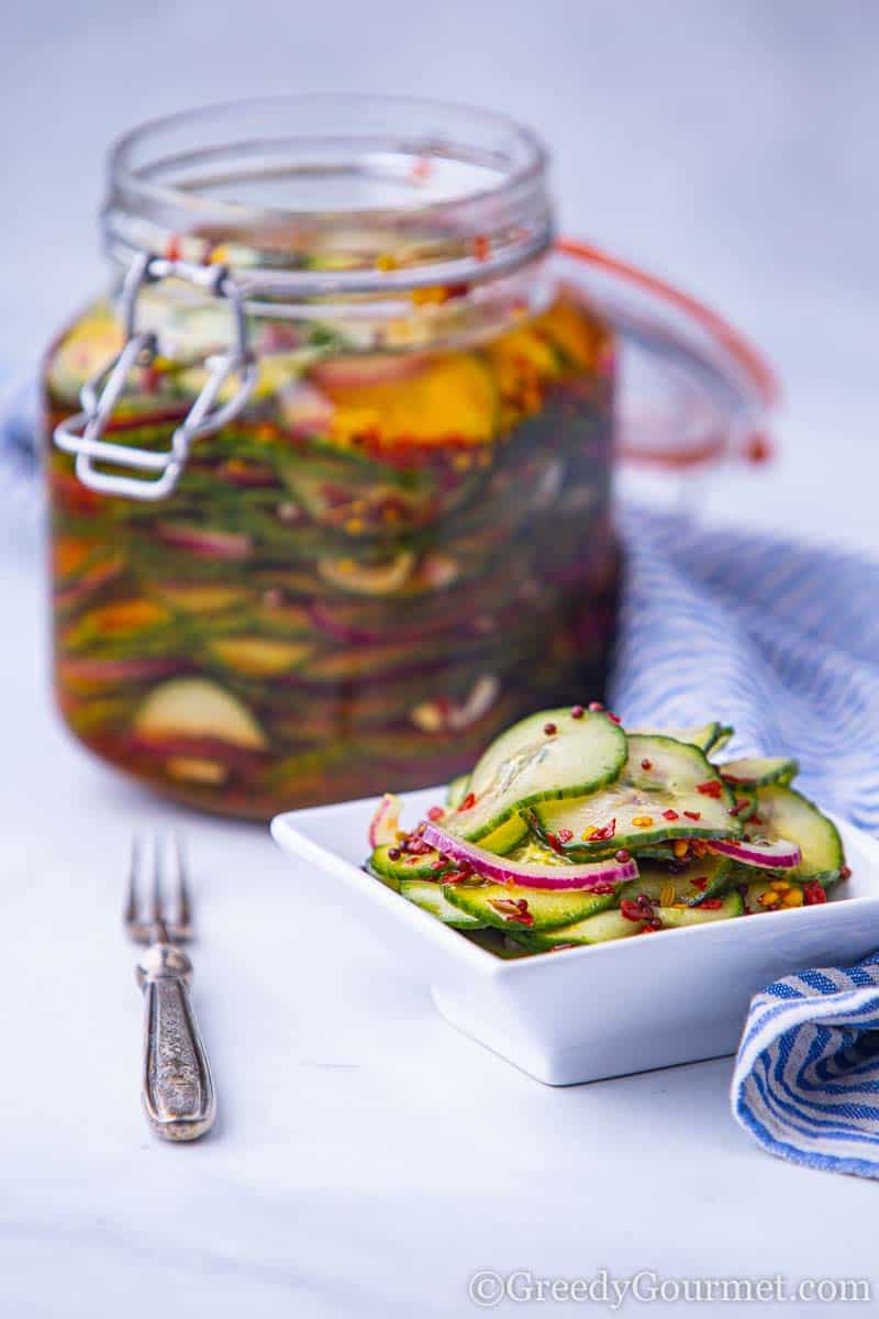 Pickled cucumbers in a plate with spices