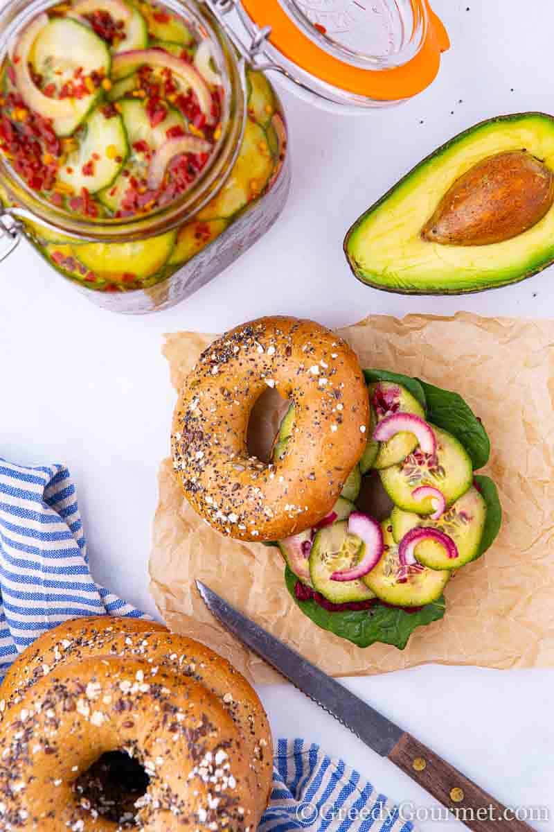 Sliced cucumbers on a bagel.