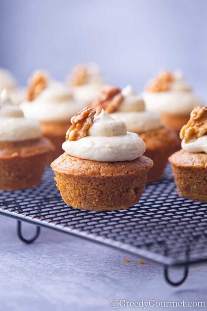 Carrot cakes on drying rack with cream cheese frosting