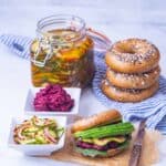 Full vegan lunch, pickled cucumbers, avocado and hummus on a bagel