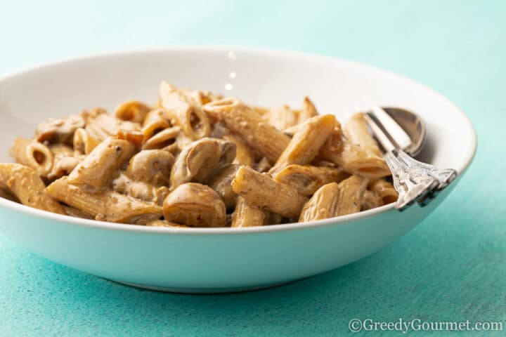 bowl of pasta and mushroom covered in sauce