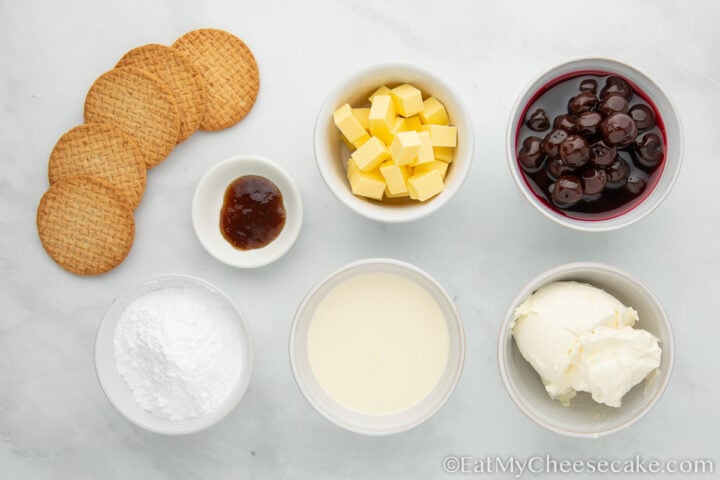 picture with biscuits, butter, cherries, icing sugar and heavy cream in bowls.