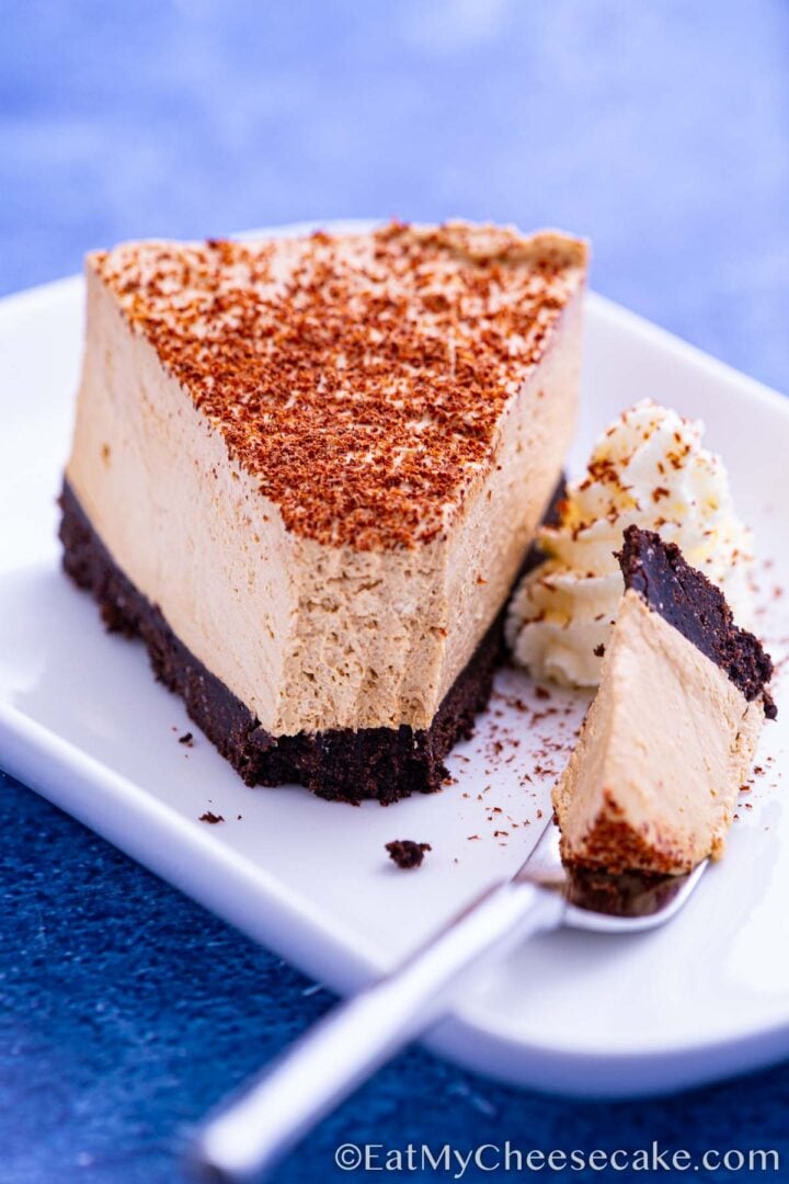 No bake espresso cheesecake slice dusted in cocoa powder.