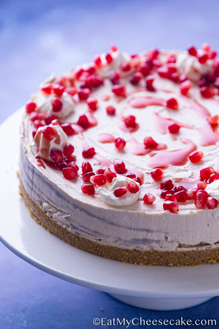 pomegranate cheesecake decorated with fresh pomegranate.