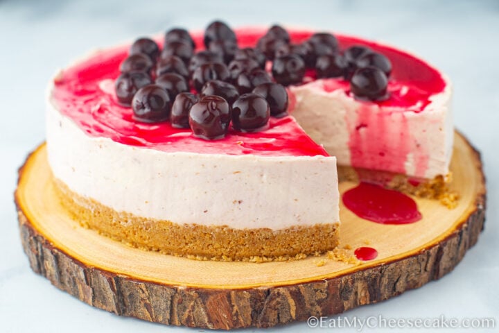 No bake cherry cheesecake topped with cherry sauce and whole cherries.