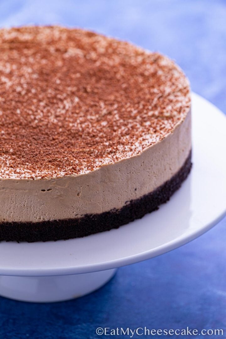 No bake espresso cheesecake dusted in cocoa powder.