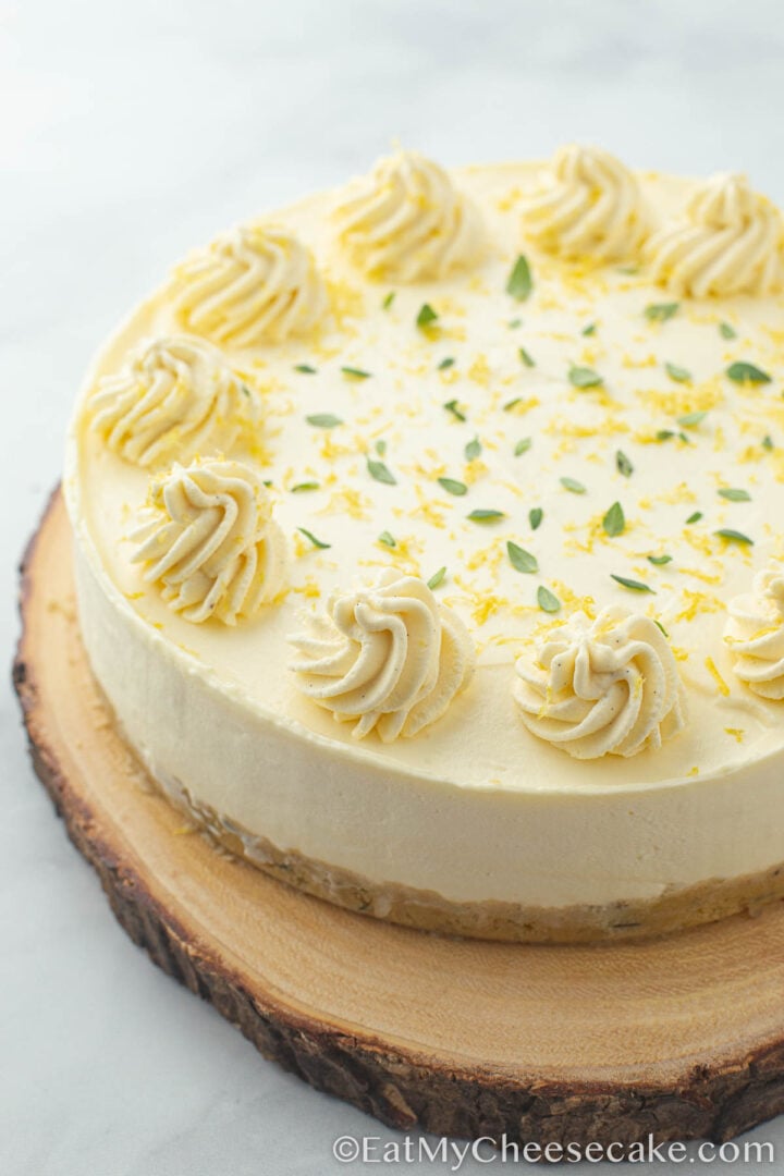 no bake lemon cheesecake decorated with whipped cream and lemon zest.