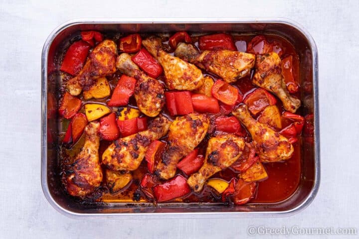 Chicken in dish with peppers straight out of the oven