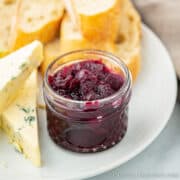 Short glass jar of a black grape chutney recipe