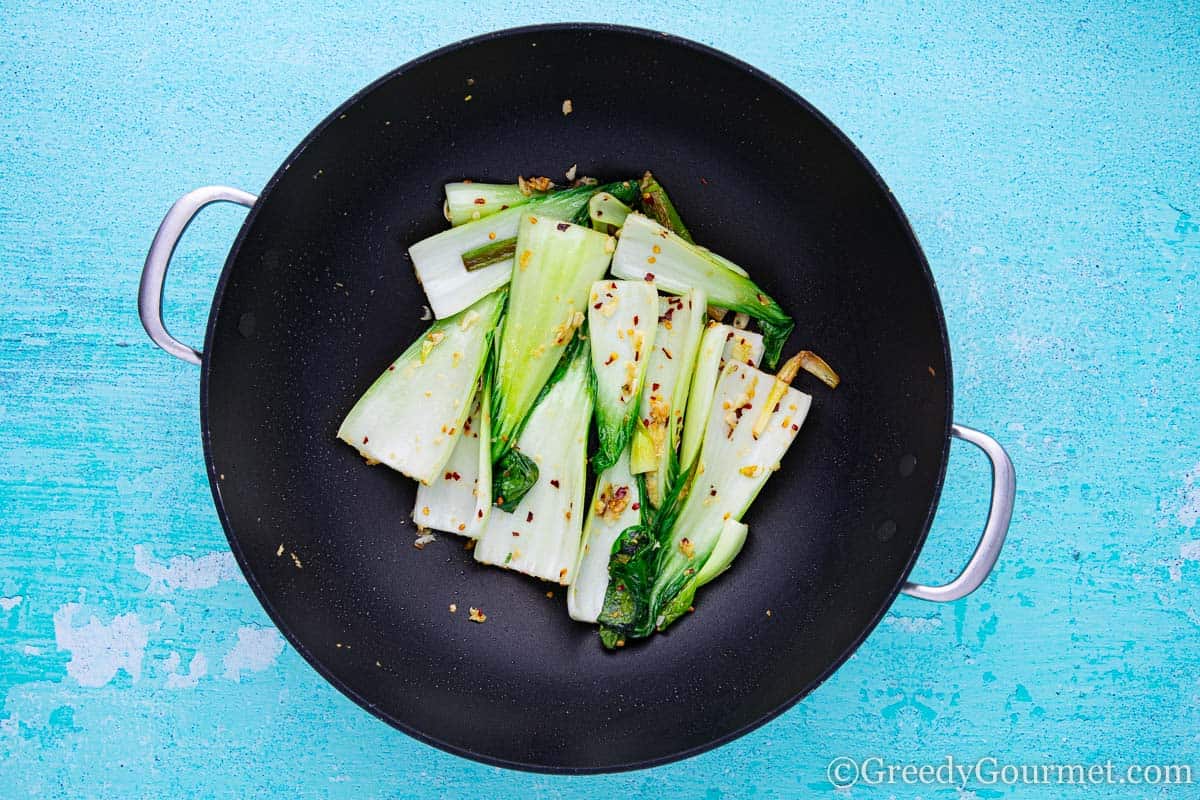 Bokchoy in a wok to learn how to make a bok choy recipe.