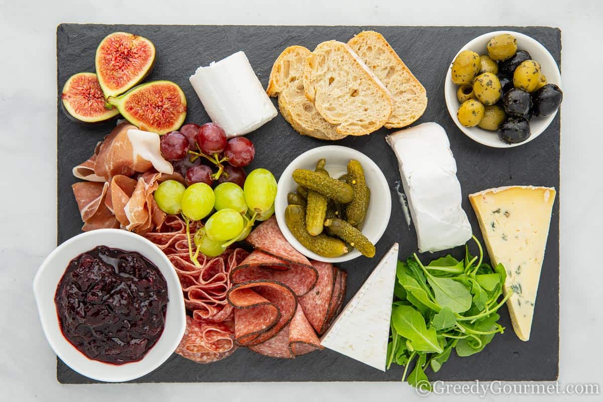 A cheeseboard of blueberry goats cheese and bread.