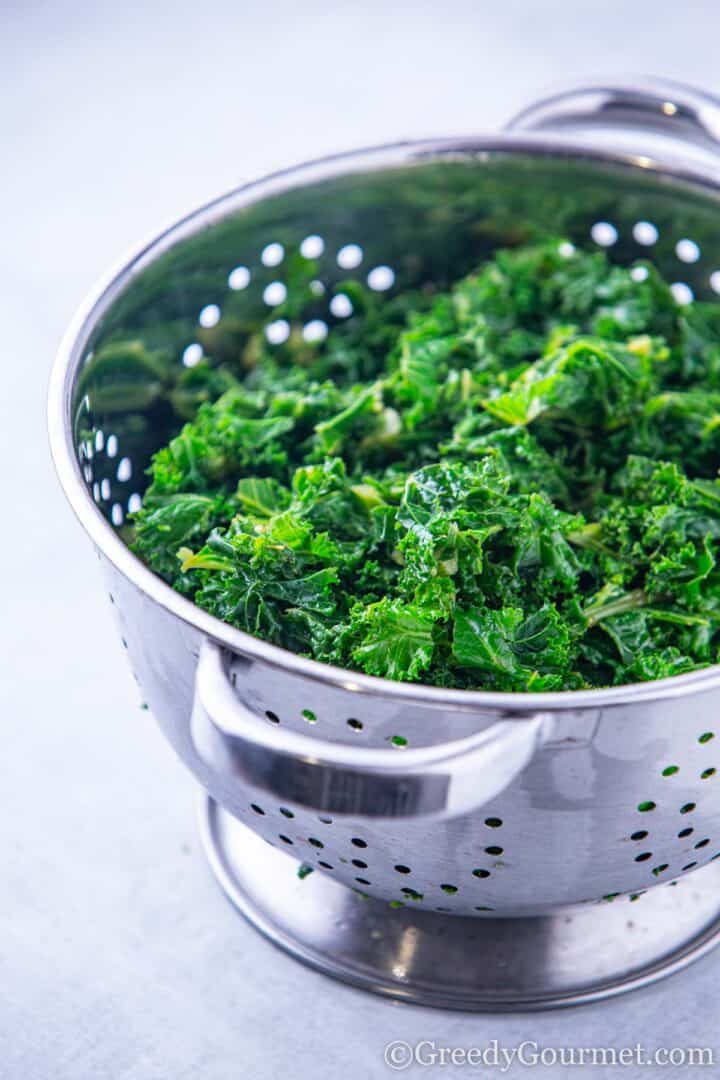 Blanched kale in colander.