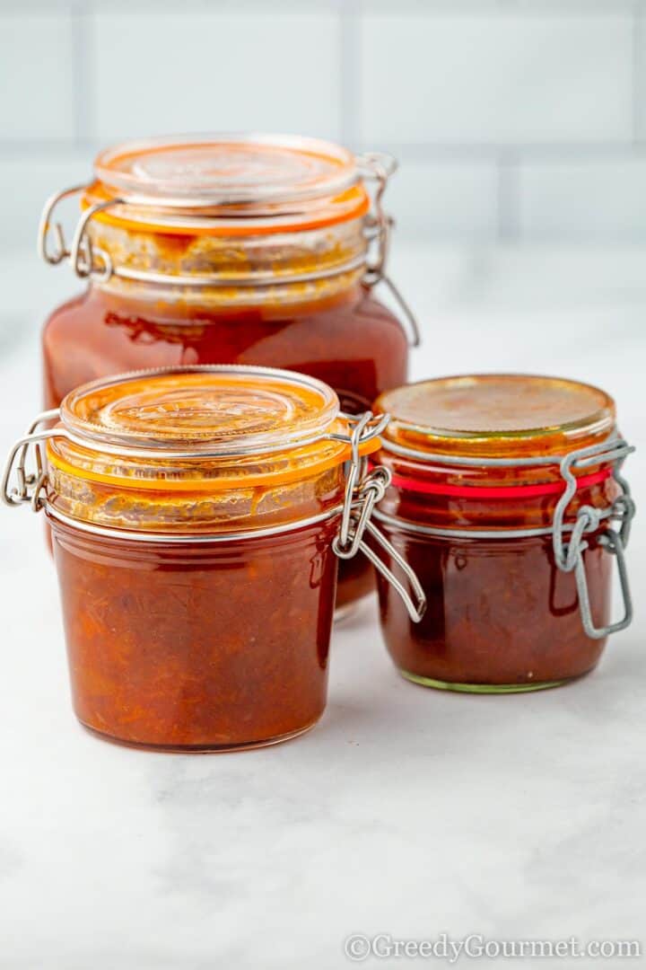 Three jars of an apricot chutney recipe.