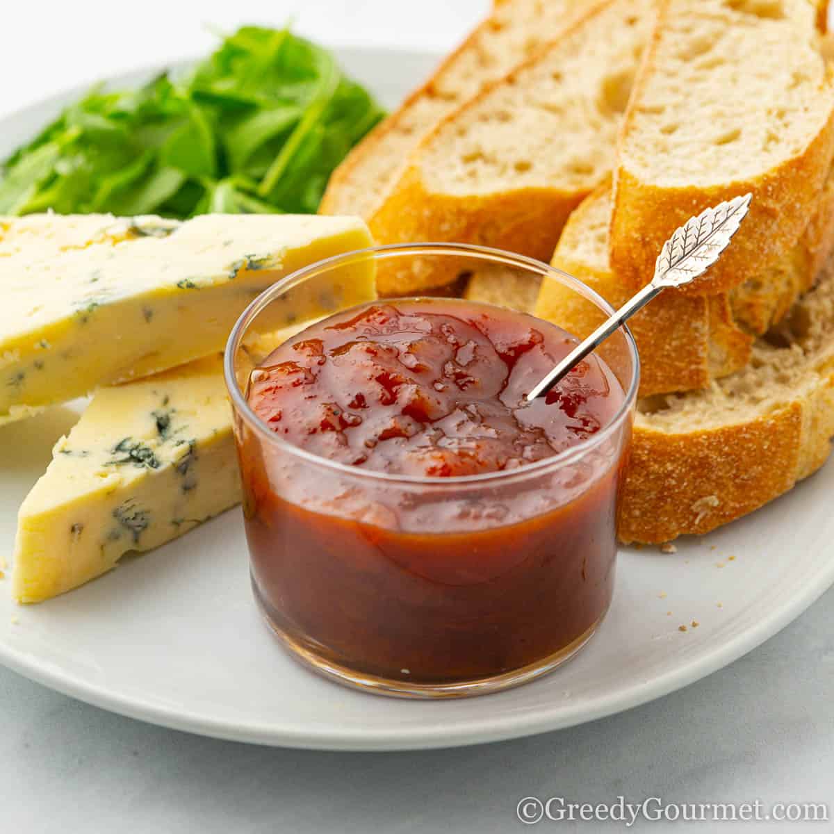 Jar of apricot chutney with cheese and bread