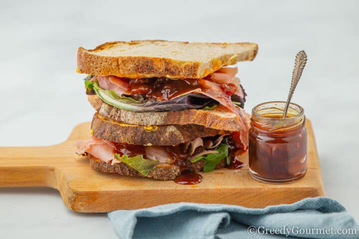 sandwich with kumquat chutney on a wooden board