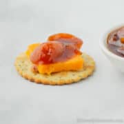 kumquat chutney and cheese on a cracker.