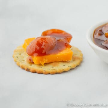 kumquat chutney and cheese on a cracker.