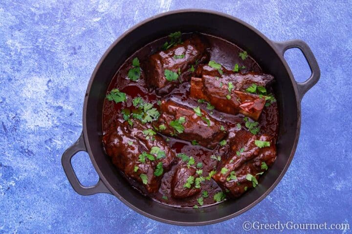 Braised short ribs with herbs on top