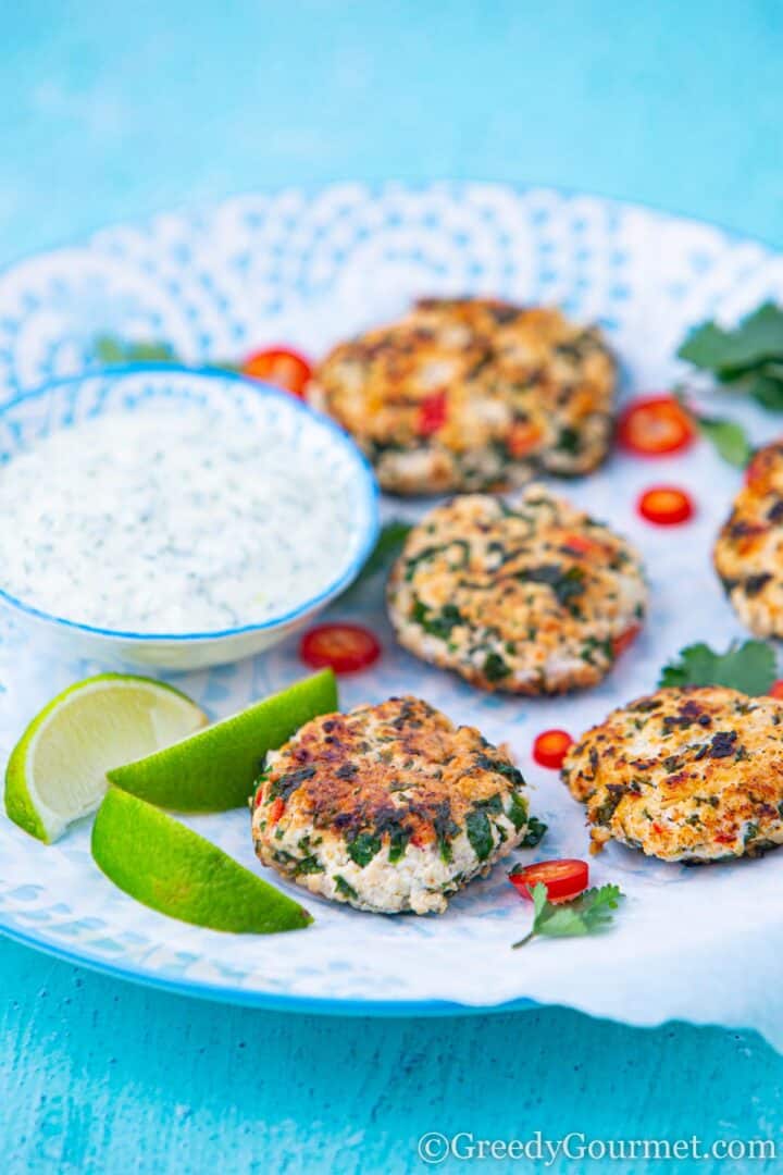 Thai Shrimp Cakes served with lime and peppers alongside a prawn dip