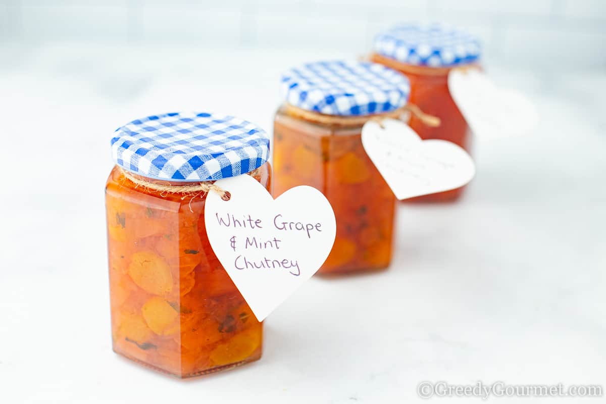 Three jars of a white grape chutney recipe.