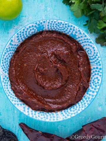 What is adobo? Its a bowl of brown sauce seen in this image