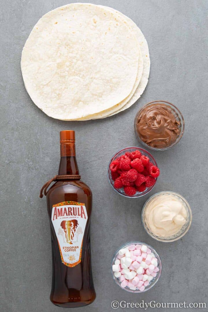 Ingredients to make dessert tortilla wraps with a bottle of Amarula