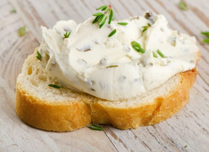 Cream cheese with chives spread over bread