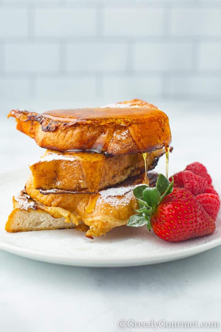 Eggnog French Toast with maple syrup and strawberries