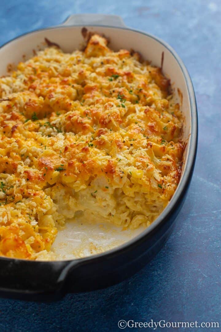 cooked cauliflower cheese pasta in a baking dish.