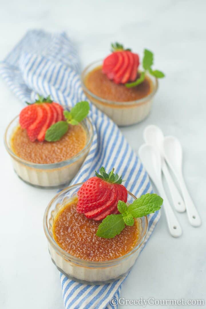 Eggnog crème brûlée with strawberries and mint