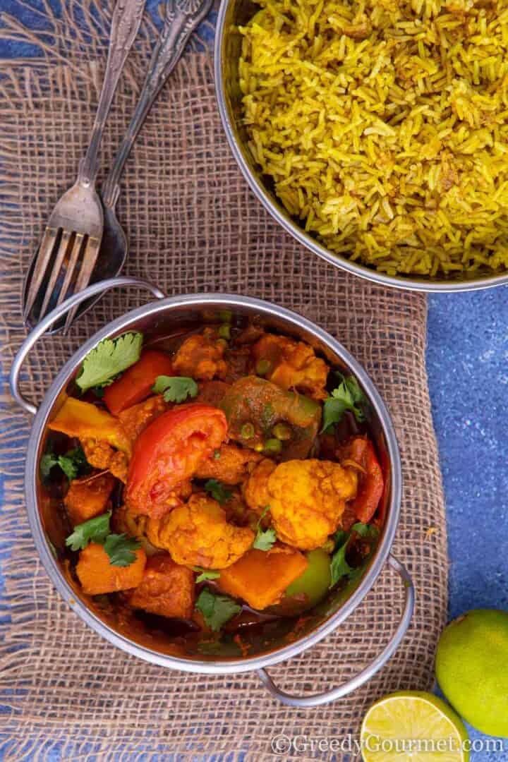 bowl of balti with a serving of rice.