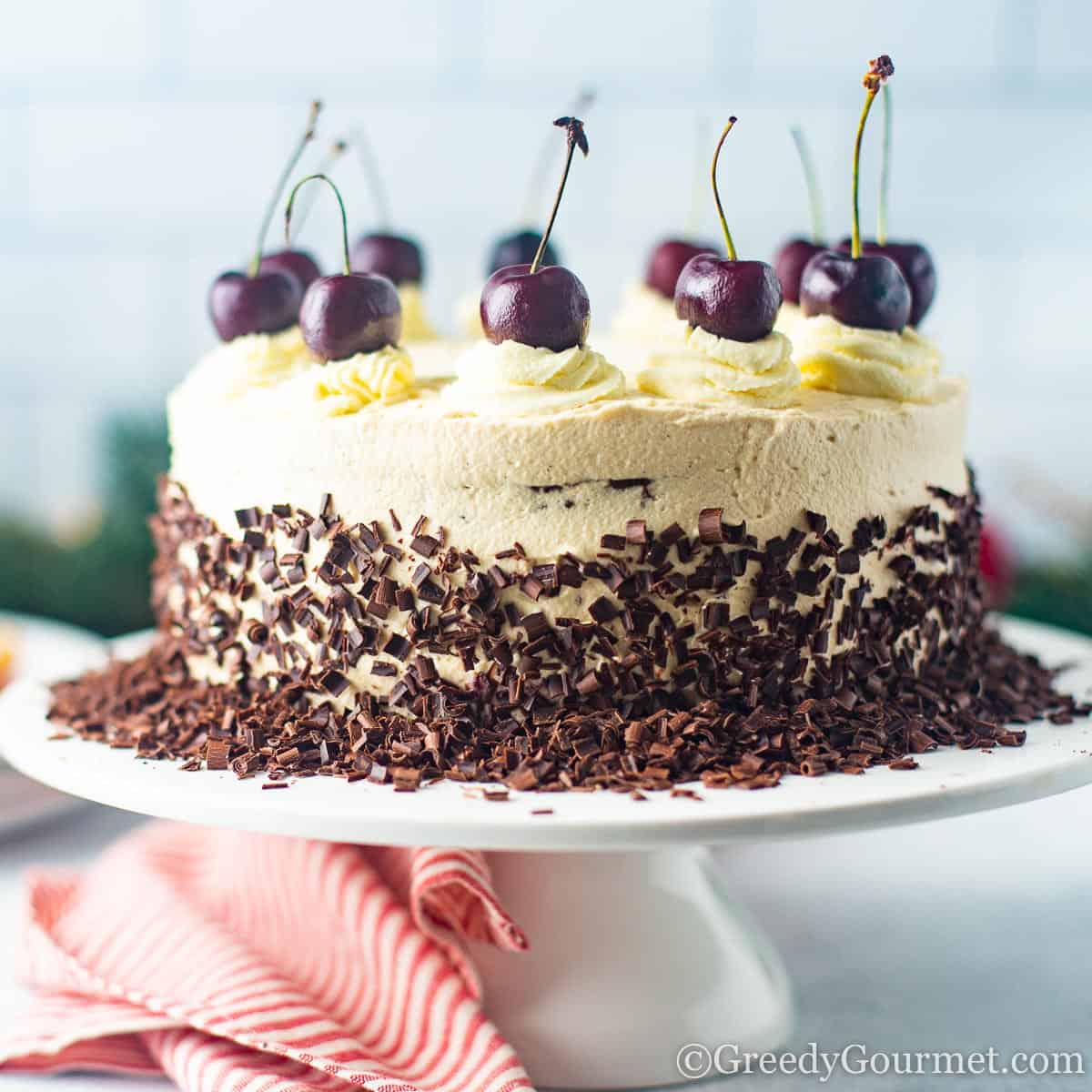 Round and decorated with cherries Black Forest Gateau