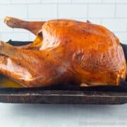 Whole roasted turkey coming out of the oven
