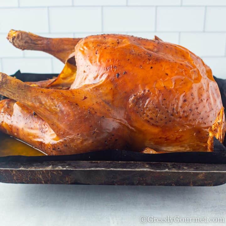 Whole roasted turkey coming out of the oven